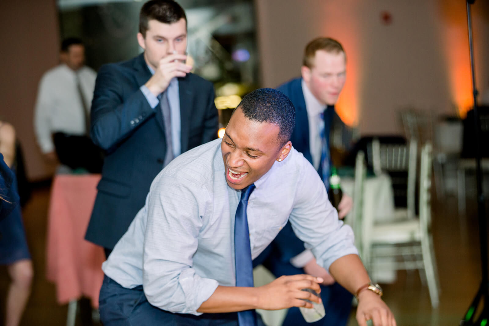 Cincinnati wedding DJs entertaining a group of men at a wedding reception.