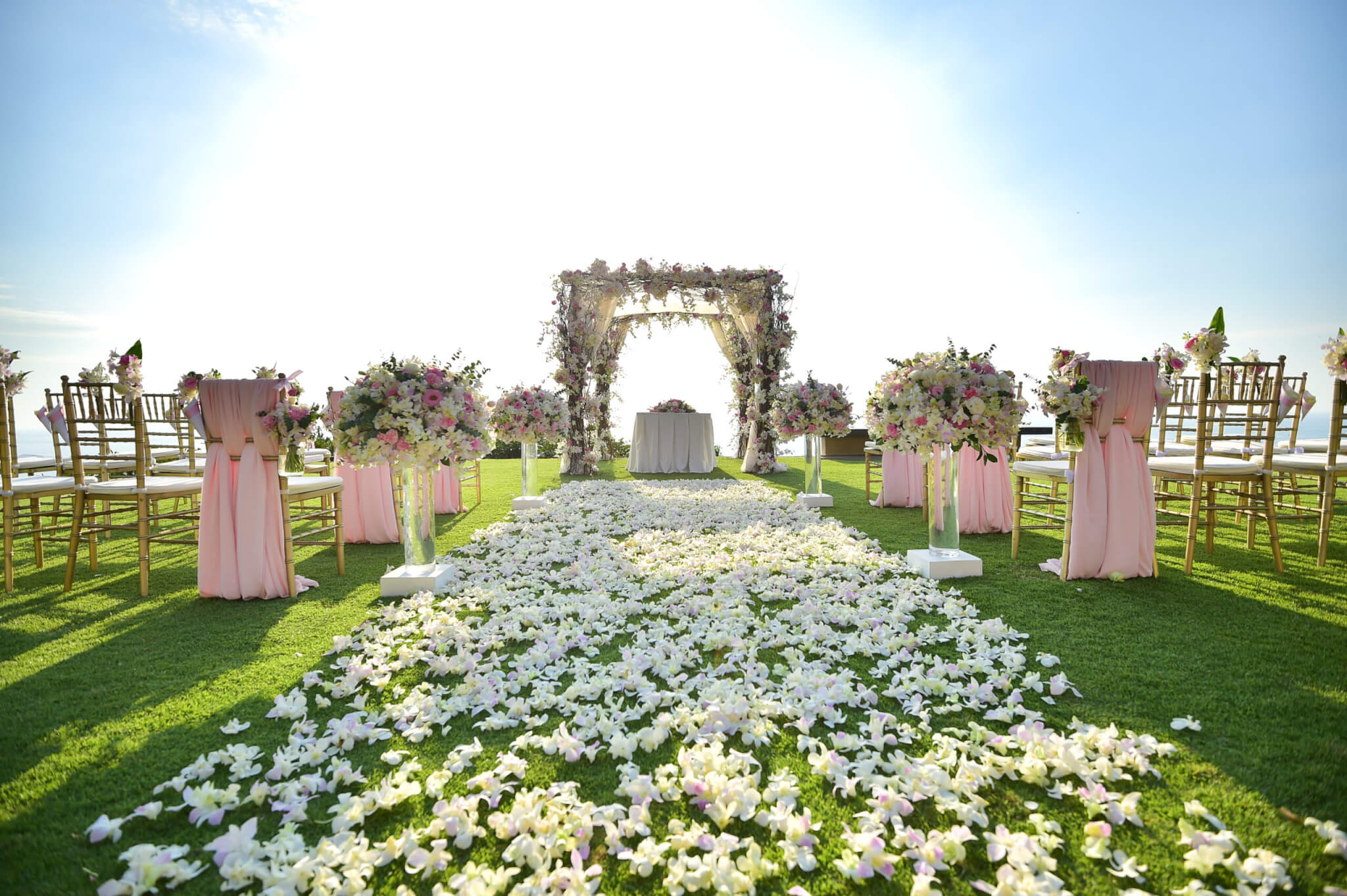 outdoor wedding ceremony with a flower petal aisle