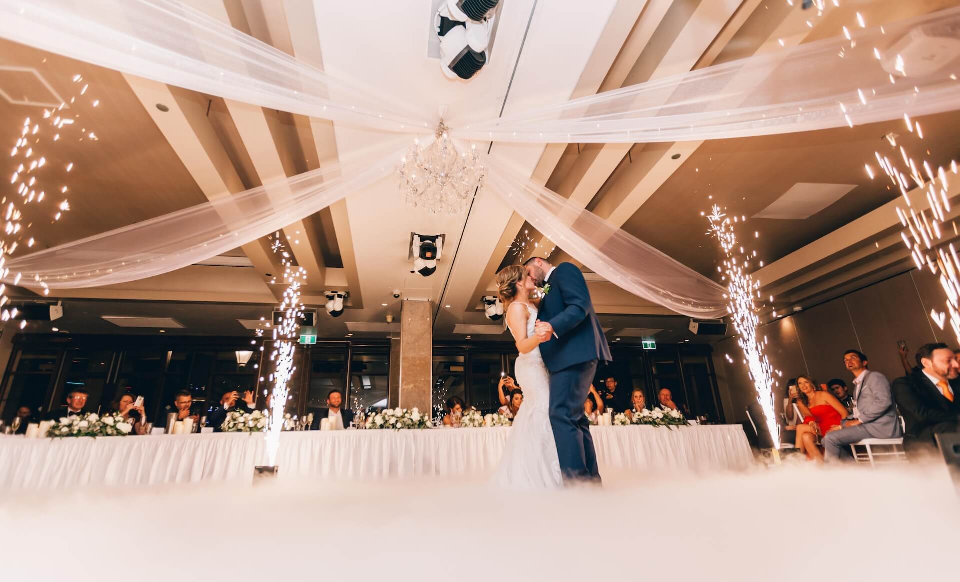 Cincinnati DJs create a magical atmosphere as a bride and groom share their first dance under a cloud of sparklers.
