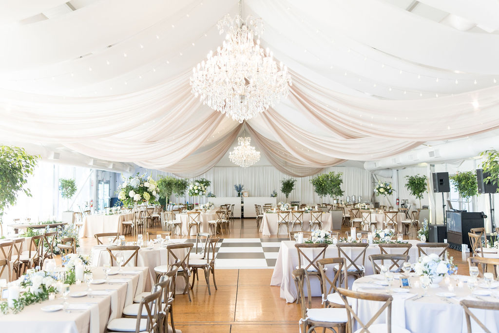 Elegant wedding venue space in with draped ceiling.